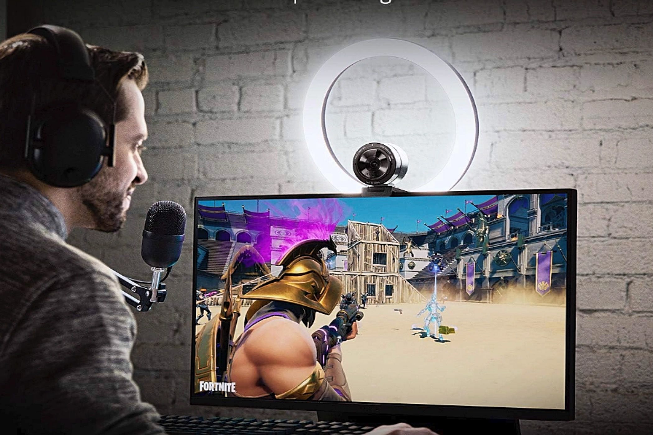 A man illuminating himself with the Razer Ring Light while playing video games