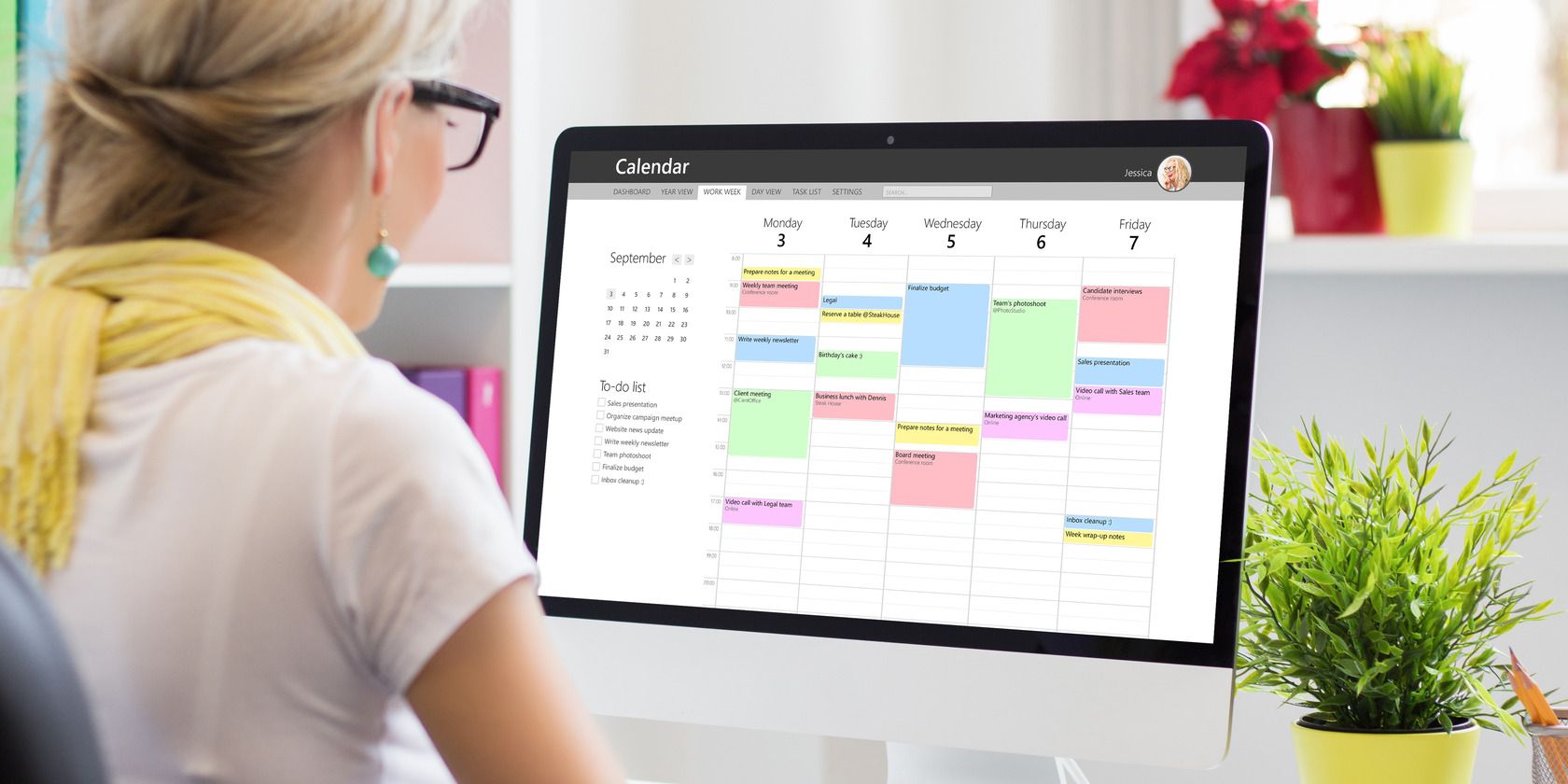 Woman using calendar app on computer in office