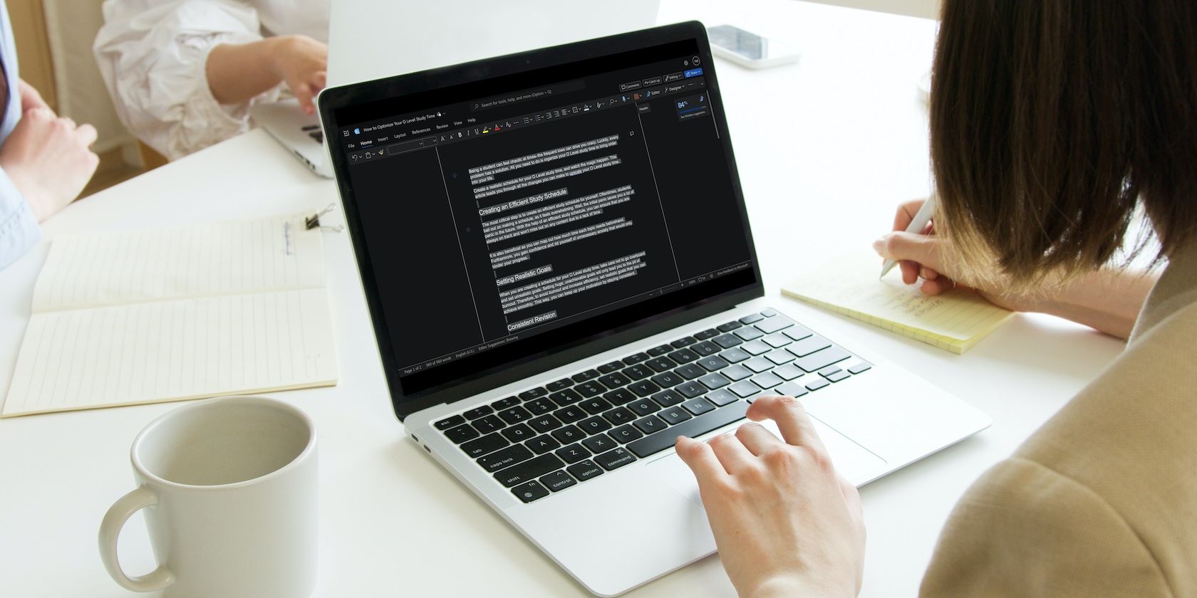 Woman using MacBook Air to duplicate a word document