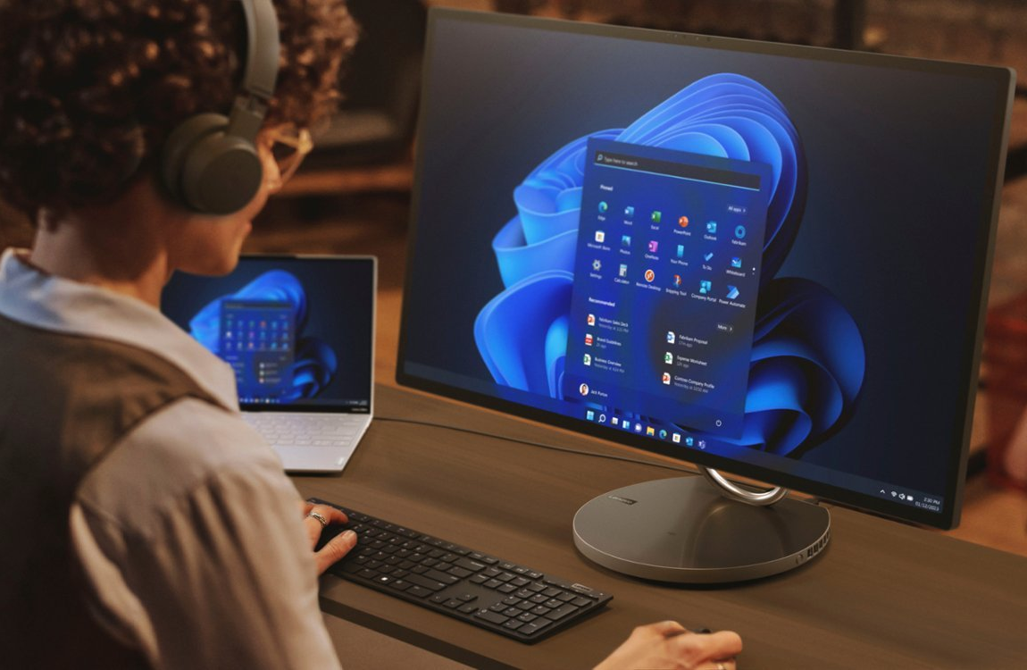 a person using a lenovo yoga 9i all in one desktop computer