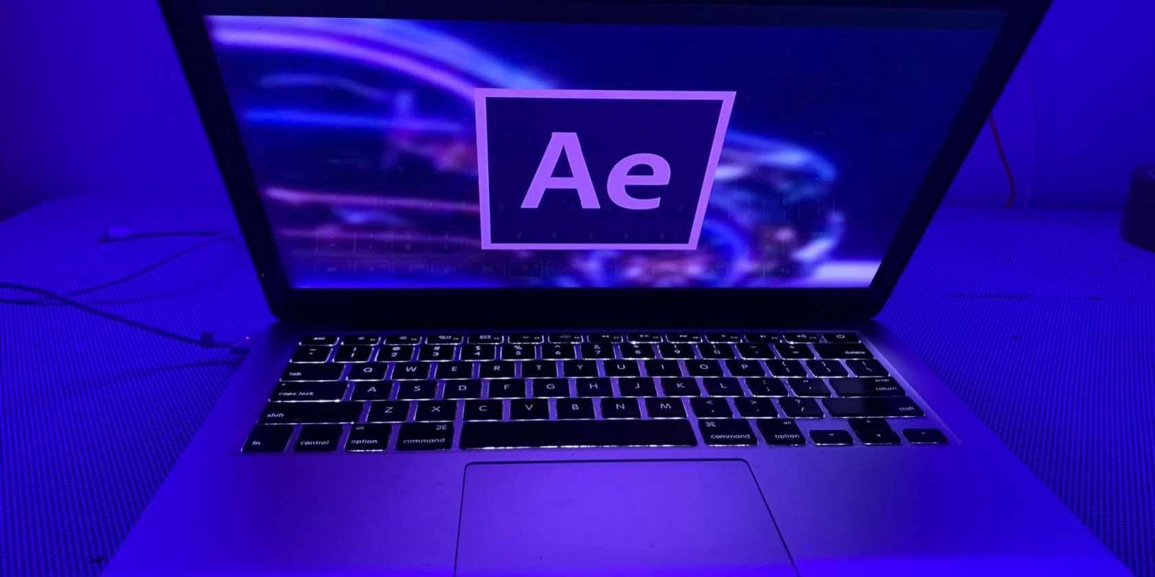 After Effects Logo on Half-Opened MacBook