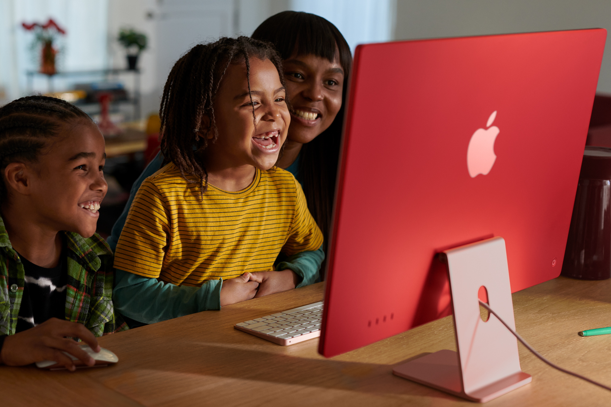 Apple 2023 iMac All-in-One Desktop Computer with M3 chip being used by a mother and her kids