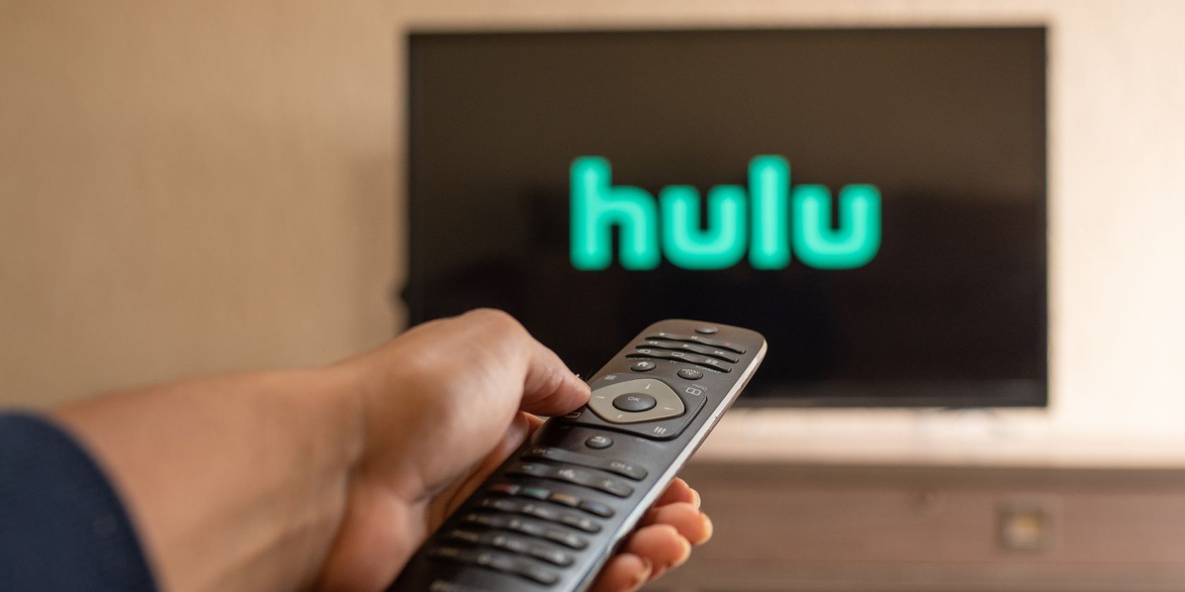 hulu logo on a tv screen with a remote pointing at it