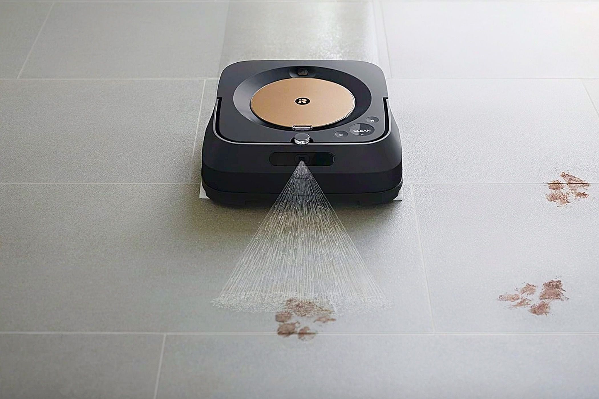 An iRobot Braava Jet M6 Ultimate Robot Mop spraying water on muddy paw prints