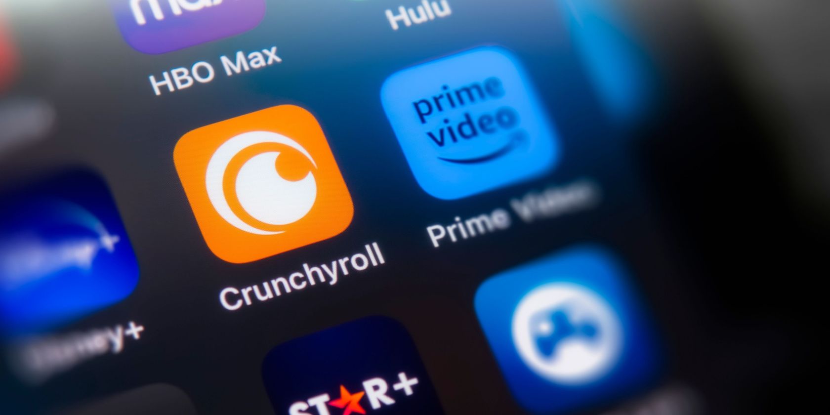 The Crunchyroll logo on a phone surrounded by other streaming apps