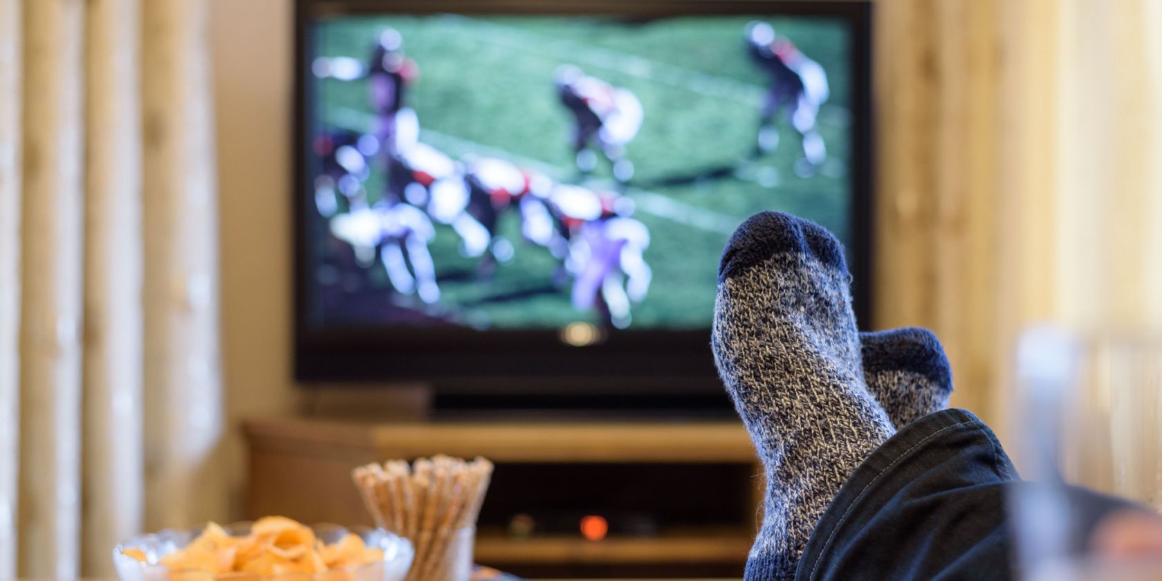 A man watching American football on TV