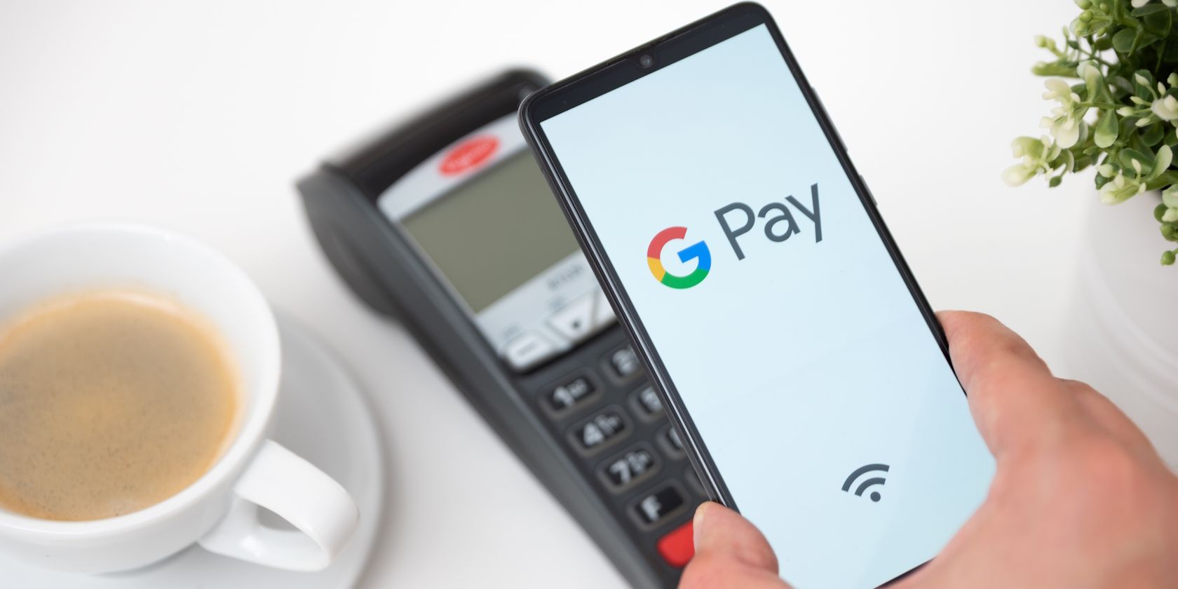A guy making a payment using Google Pay on his Android phone
