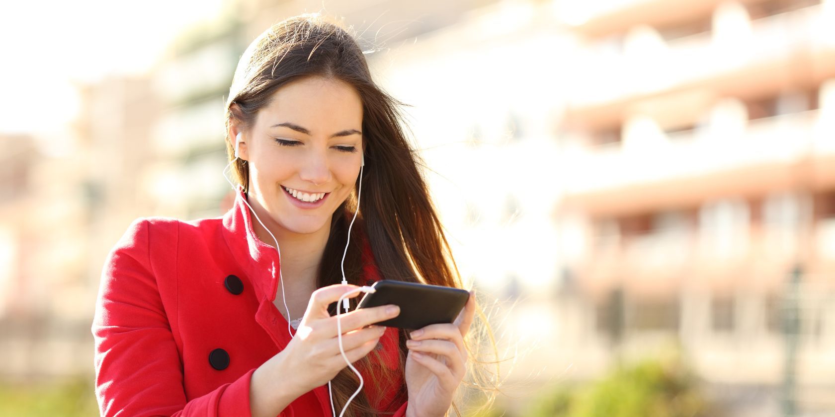 a woman with earphones connected to her smartphone