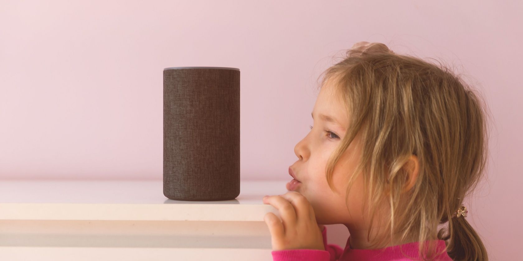 A child shouting at an Amazon Echo in order to wake Alexa up