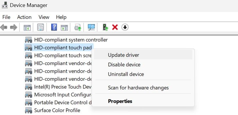 Updating the HID-Compliant touch pad driver in Windows Device Manager.
