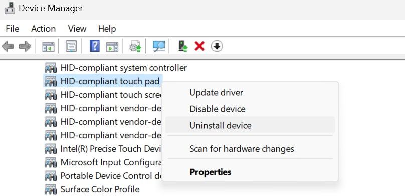 Uninstalling the HID-Compliant touch pad driver in the Windows Device Manager.