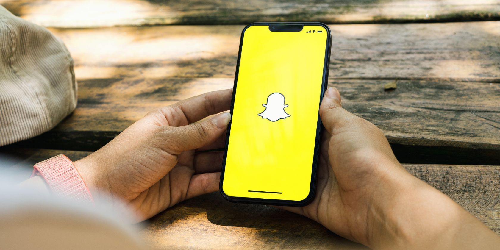 a smartphone with the snapchat app being held in someone's hands