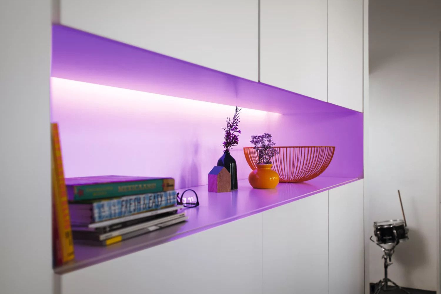 a phillips hue lightstrip plus illuminates a cabinet