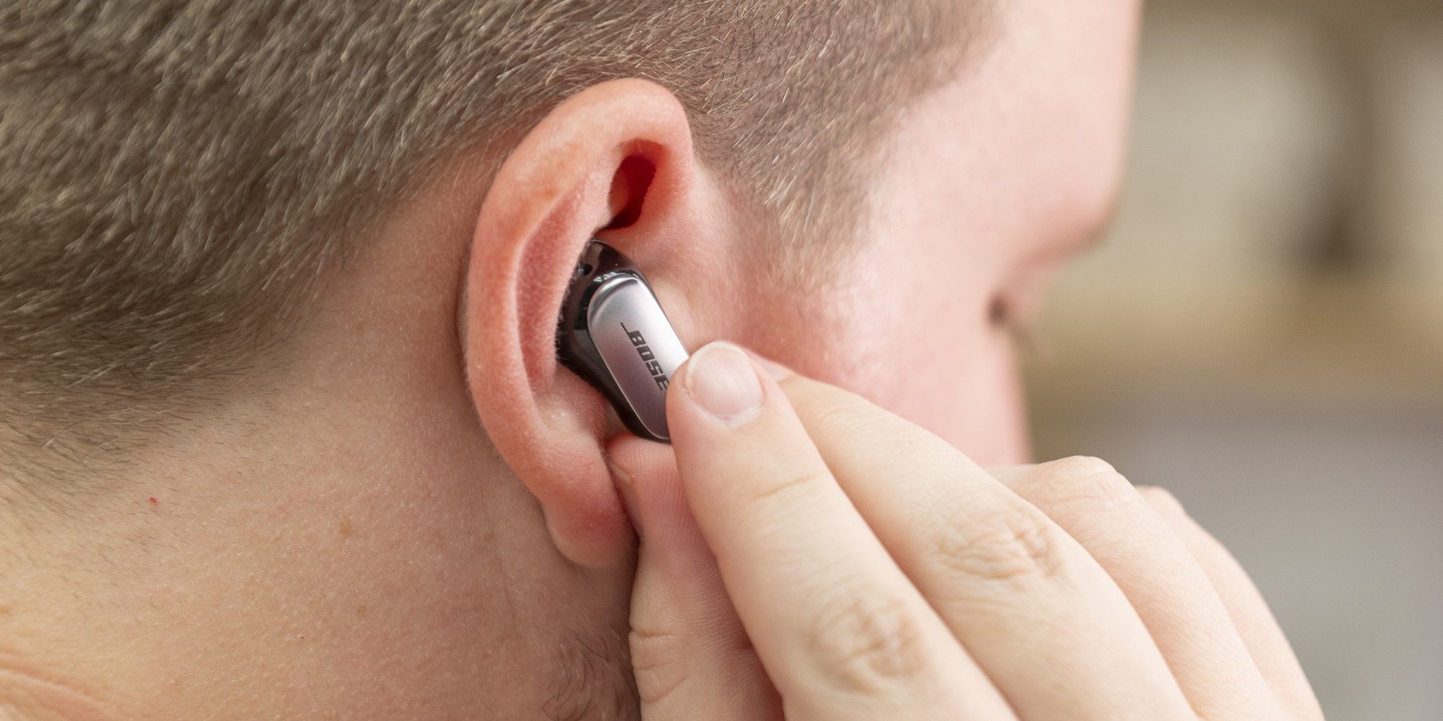 The Bose QuietComfort Ultra Earbuds touch controls being used