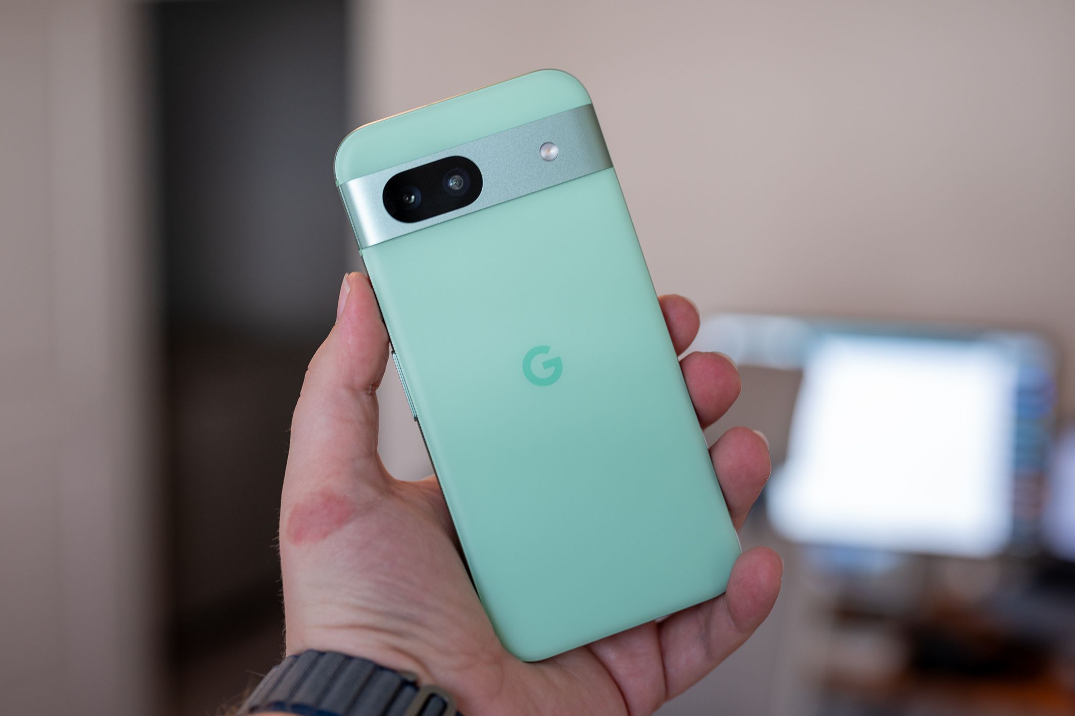 Person holding the Google Pixel 8a showing the back of the phone