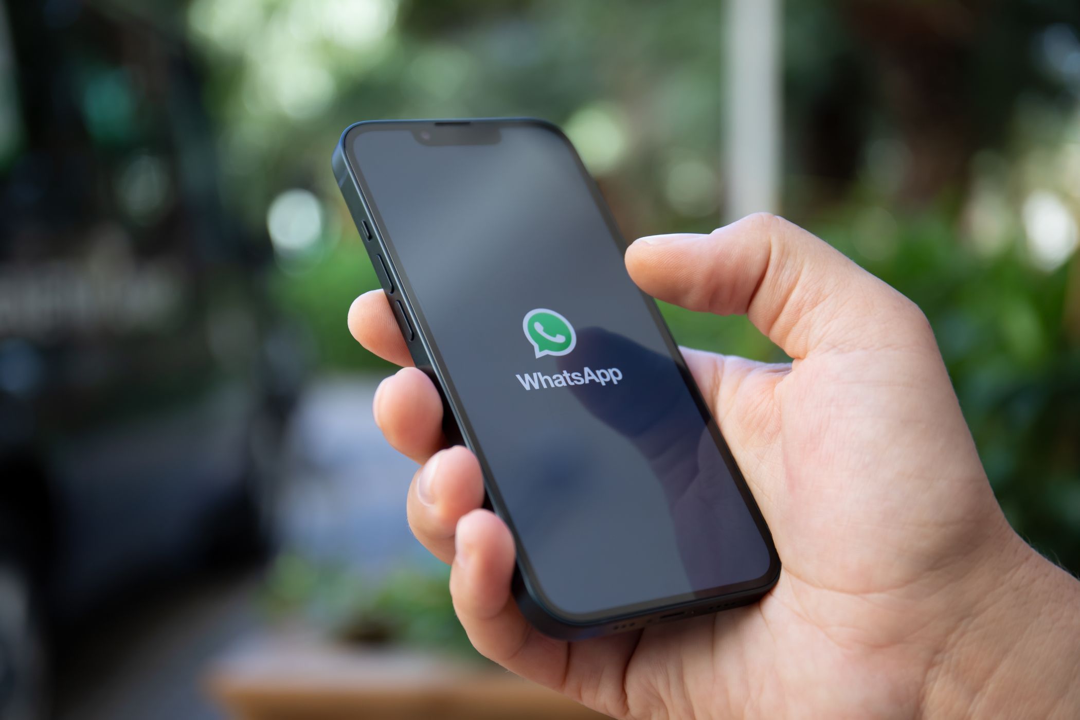 a person using a phone with the whatsapp logo