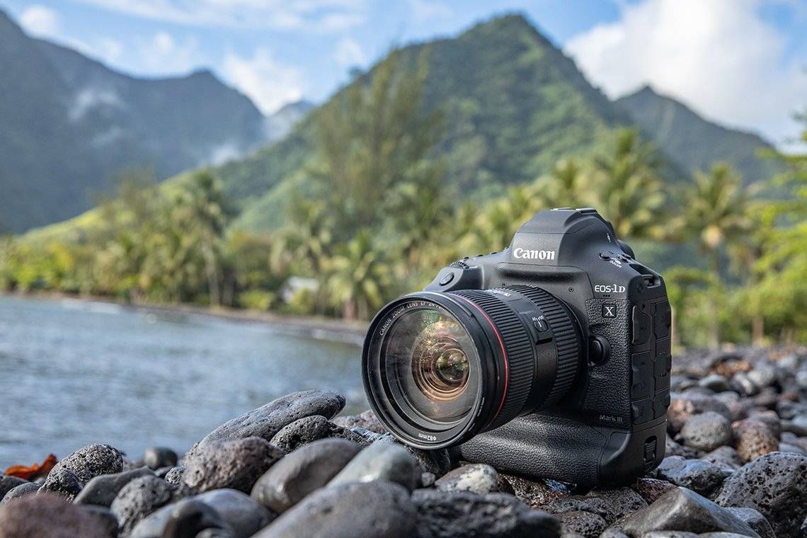 Canon EOS 1D X Mark III on a rock with a scenic background