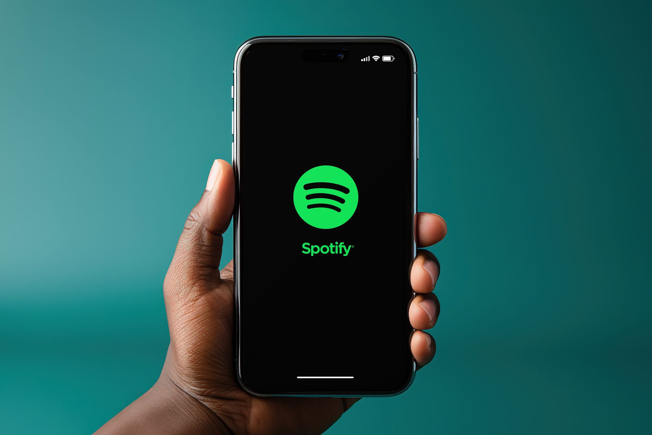 man holding smartphone with spotify logo on screen