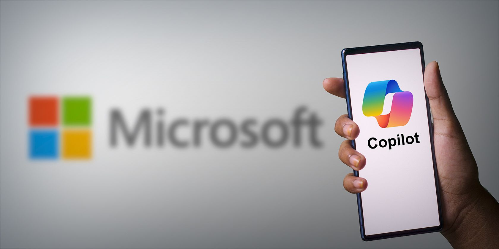 A smartphone screen displaying a Copilot logo with the Microsoft logo in the background