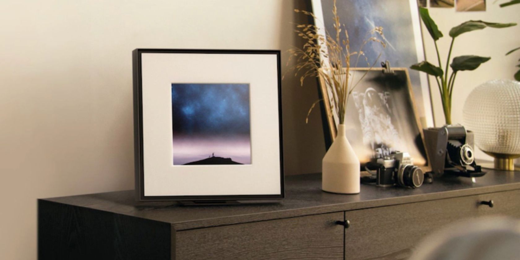 The Samsung Music Frame placed on a chest of drawers