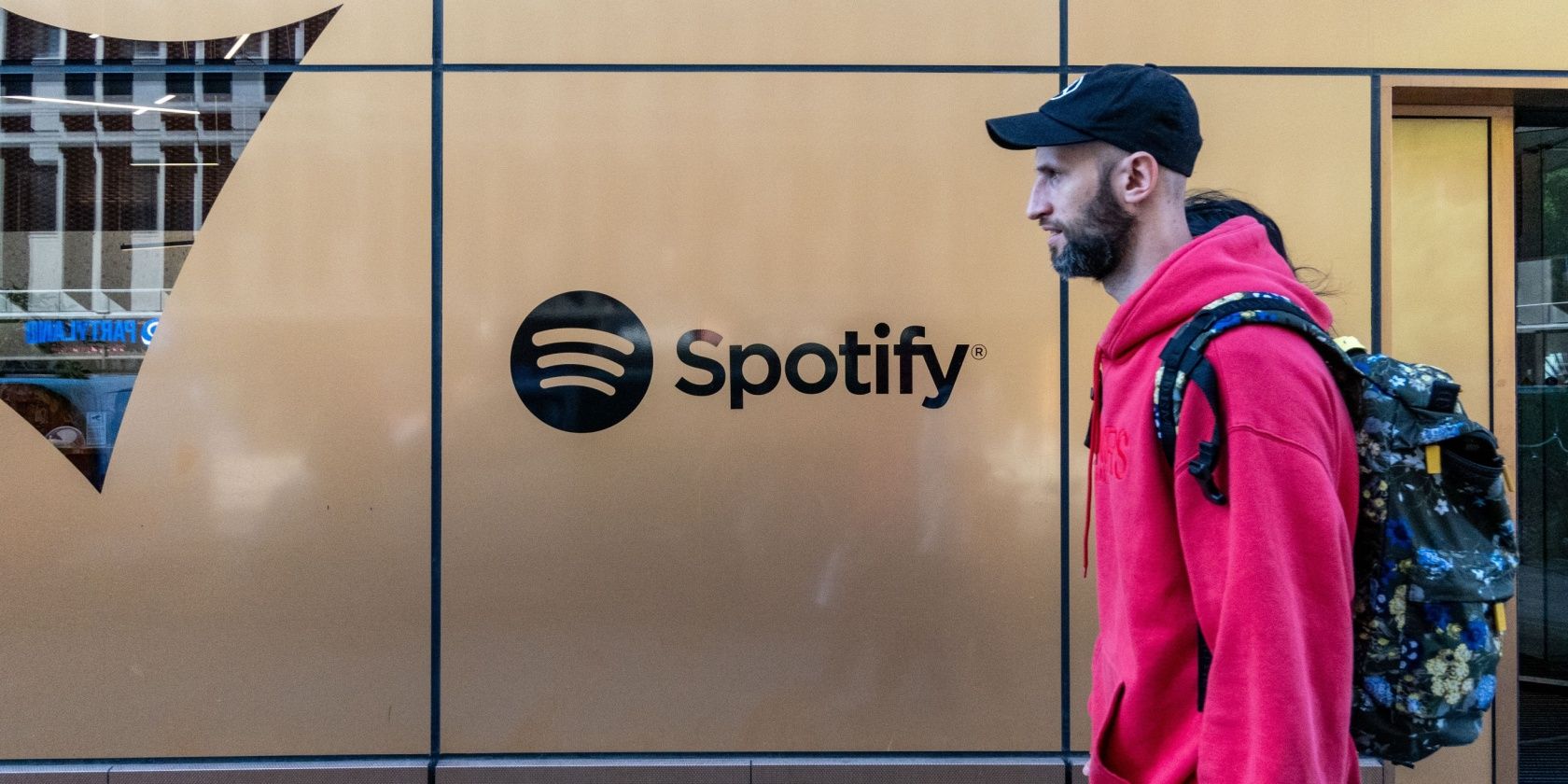 Someone walking past Spotify's headquarters