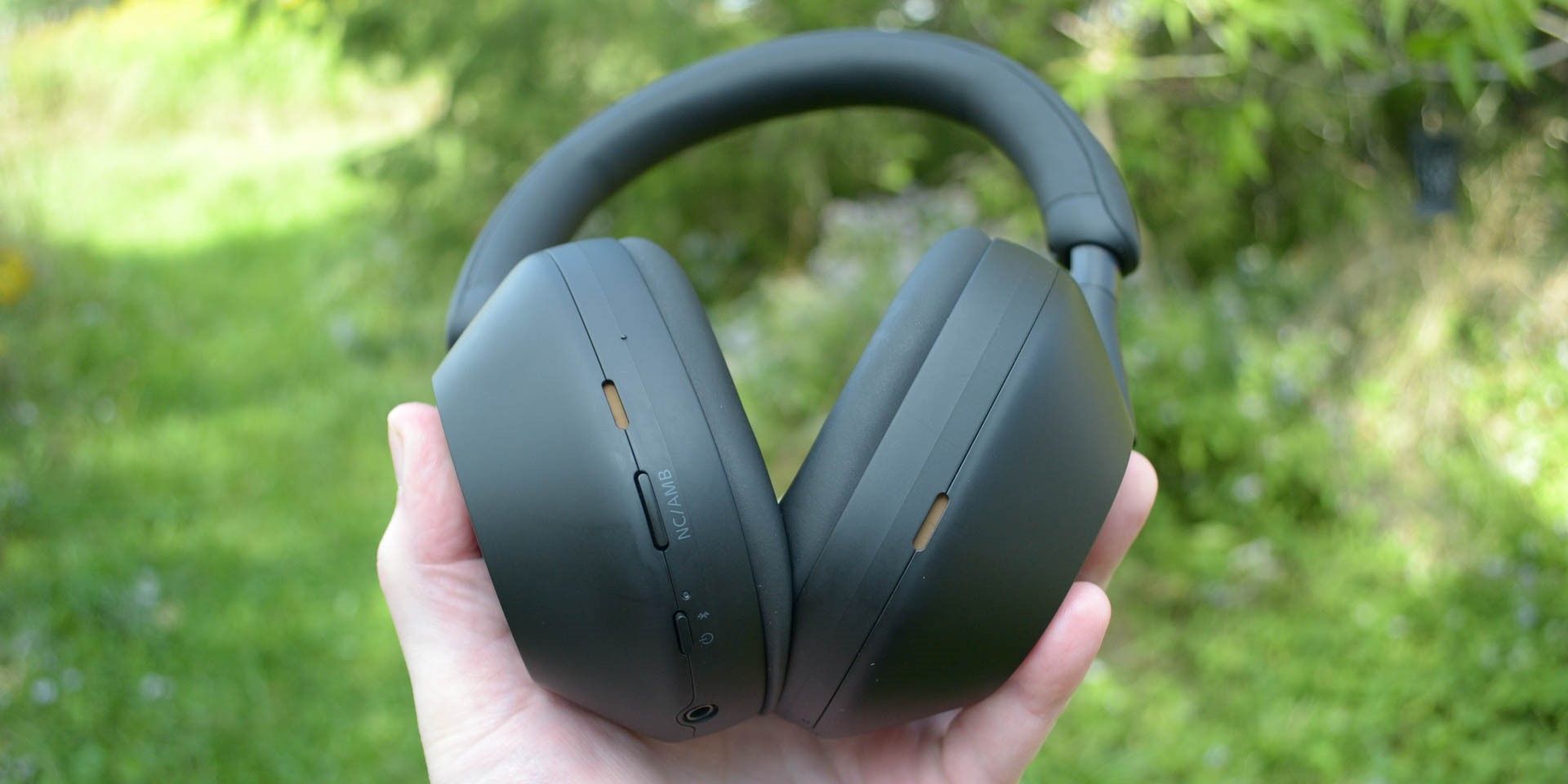 Sony WH-1000XM5 headphones in hand
