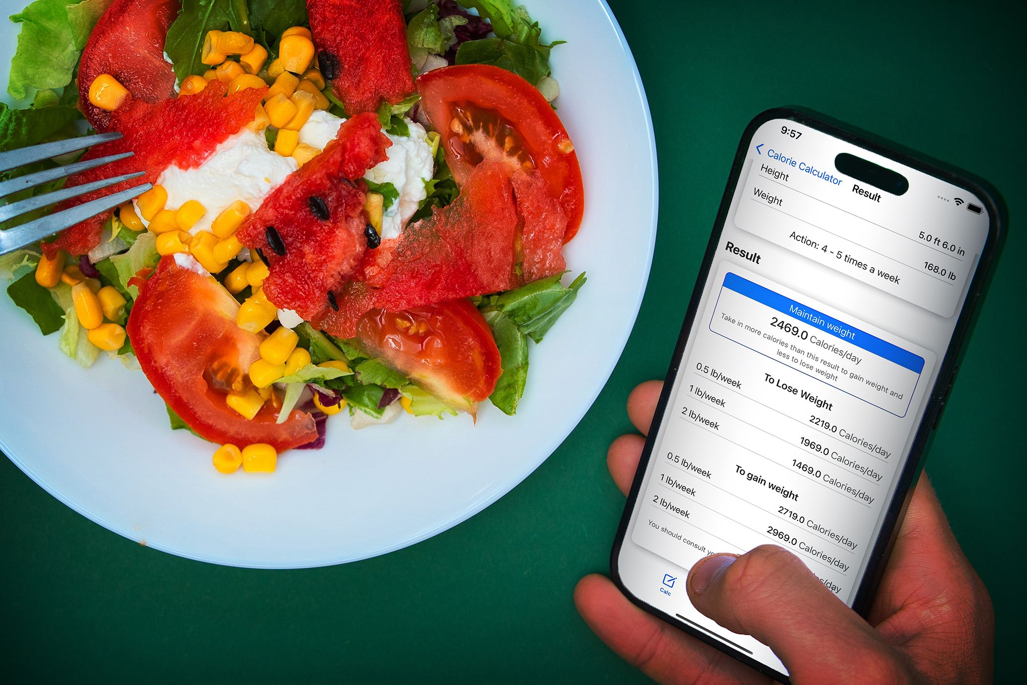 A person eatin a salad while using a cellphone showing a calorie calculator interface
