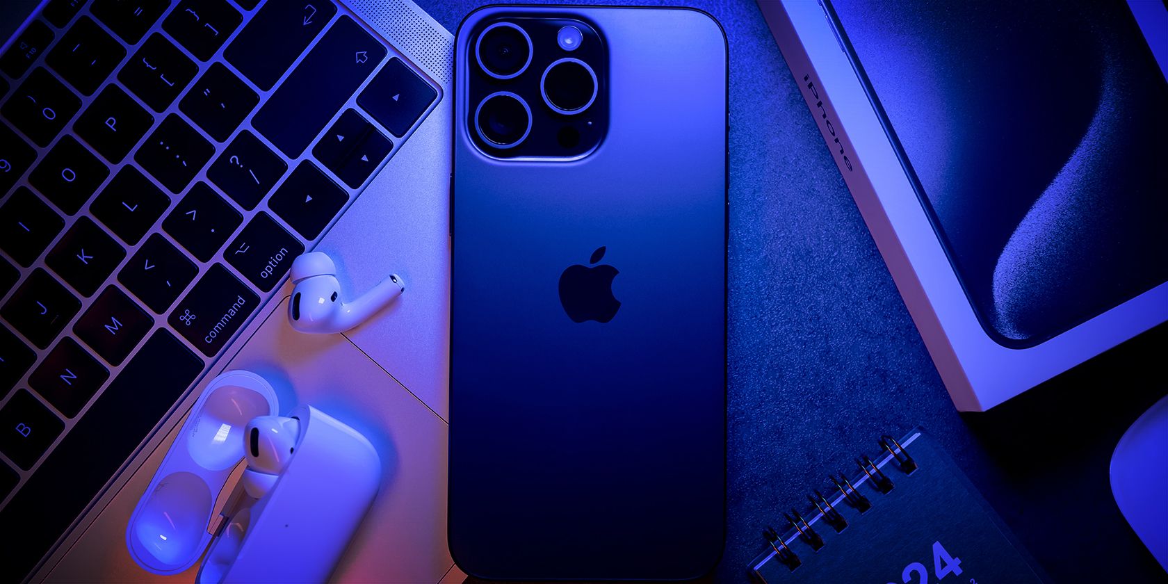 A modern, tech-themed composition and an Iphone under a cool blue light.