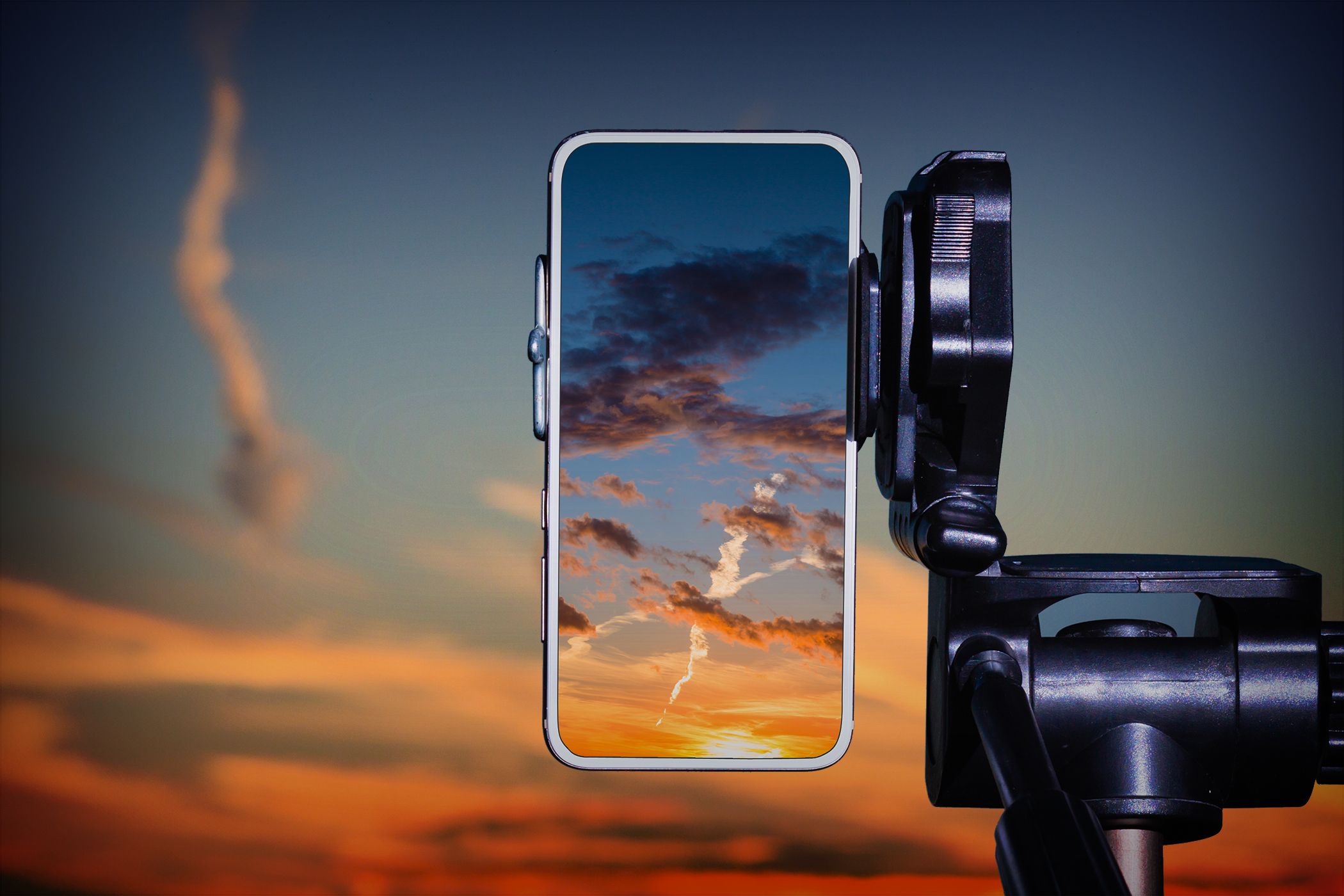 A smartphone on a tripod capturing a scenery
