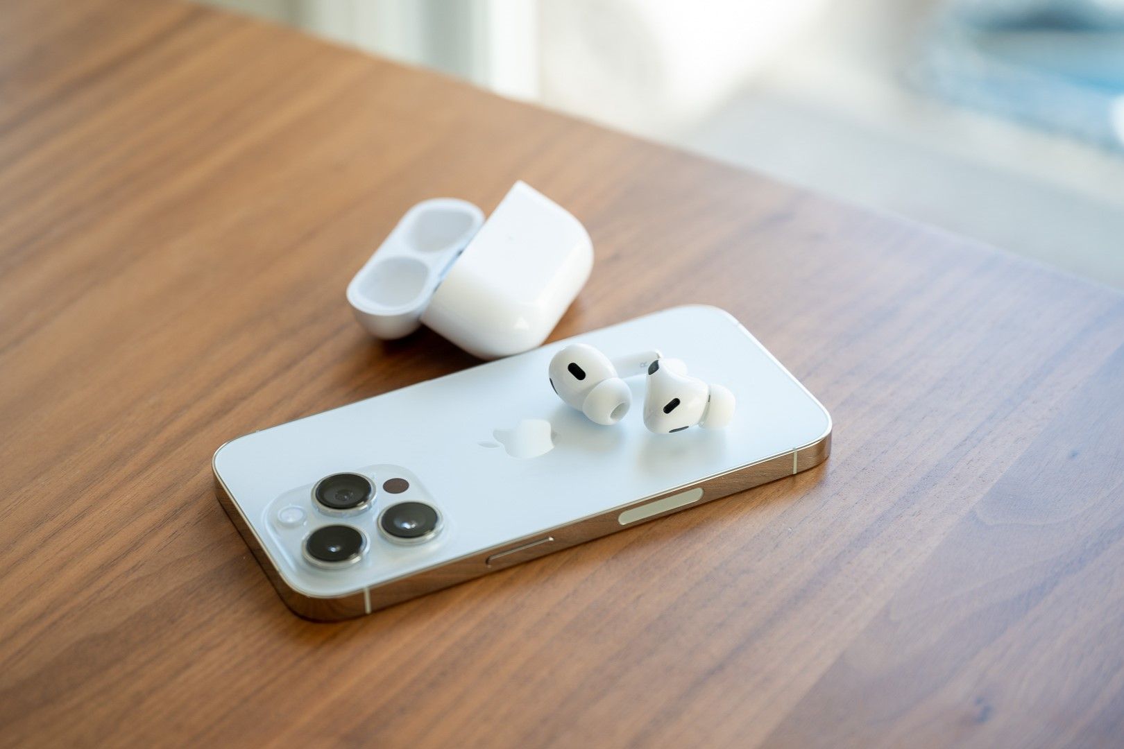 Apple AirPods Pro 2nd Gen sitting on the back of the iPhone 14 Pro