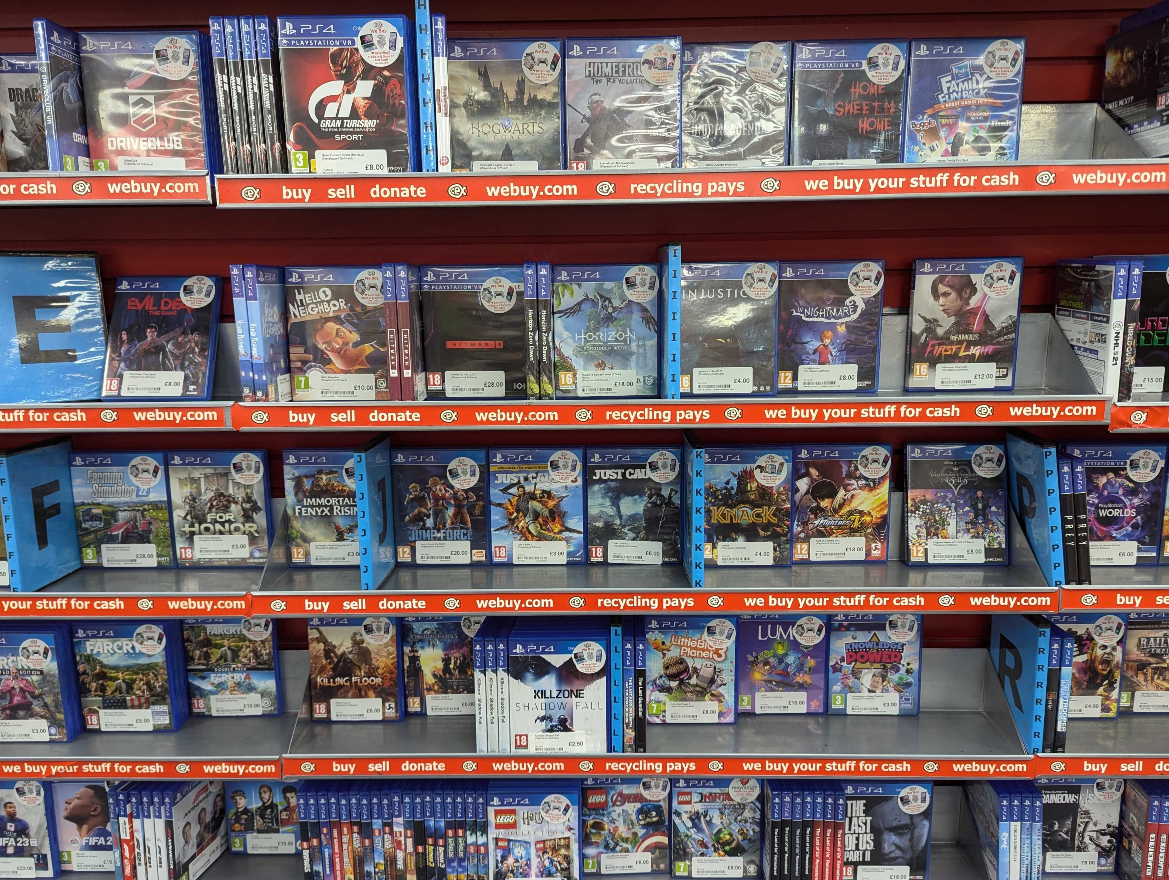 A wall of pre-owned PS4 games for sale