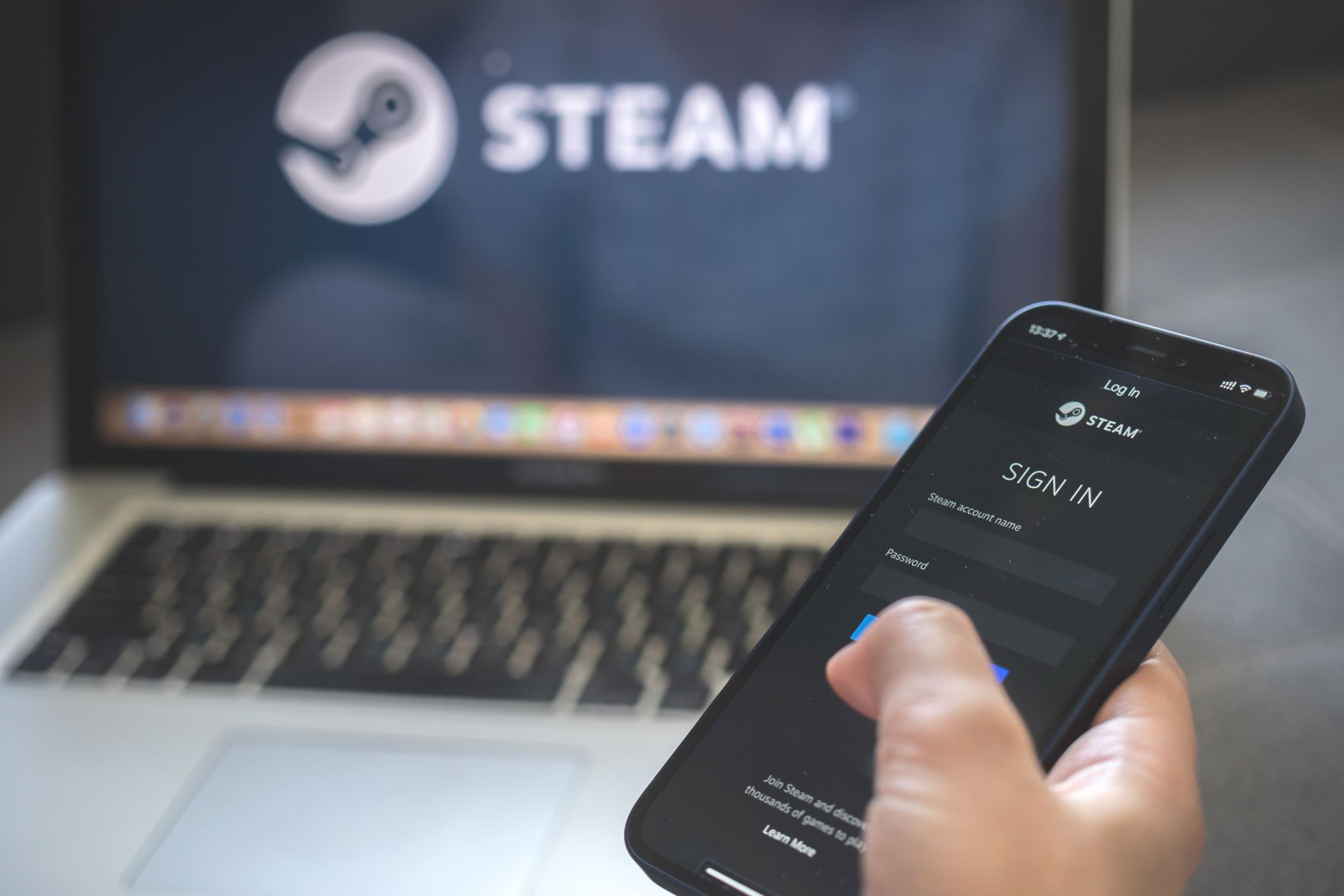 someone signing into steam on a smartphone 
