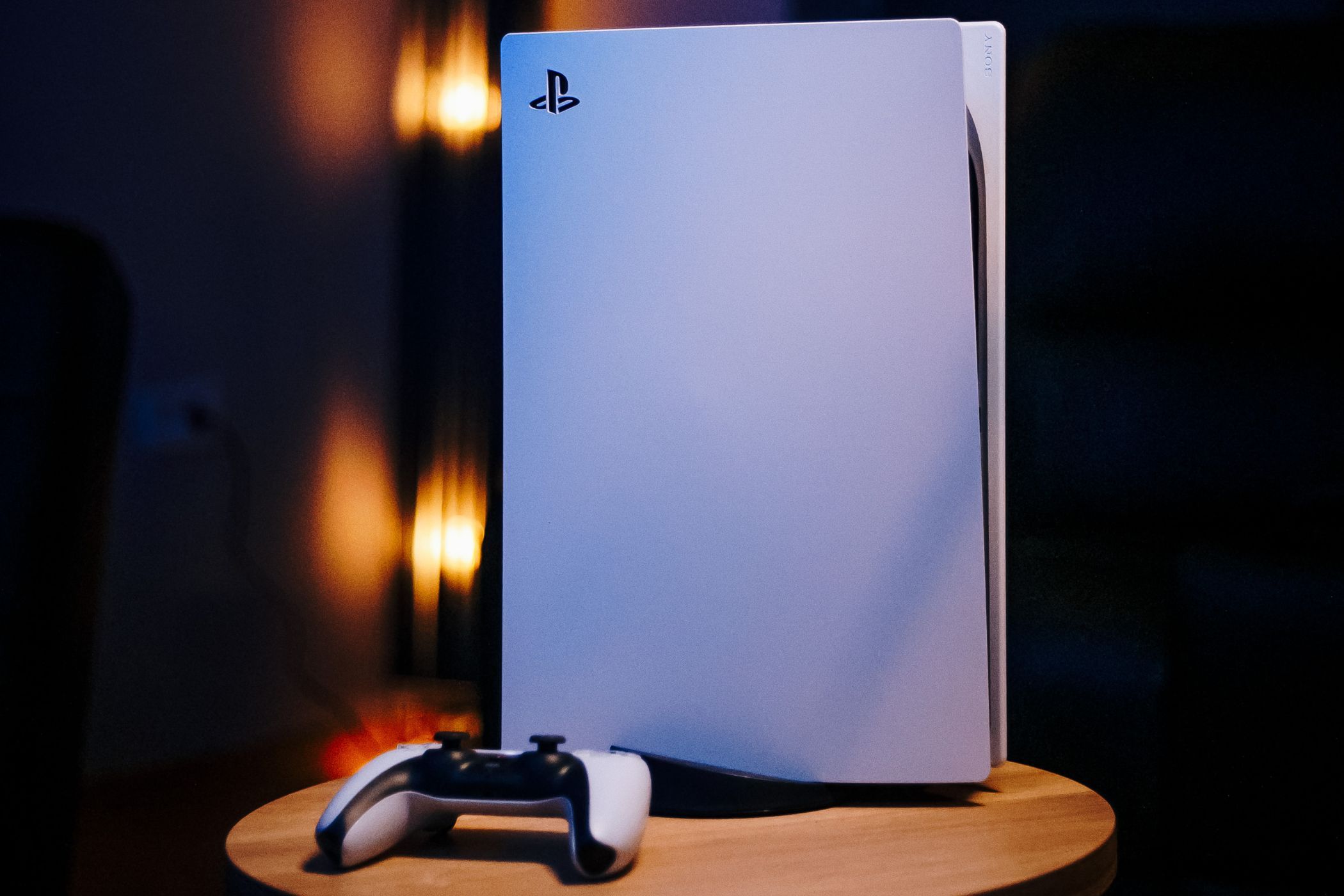 the playstation 5 console and ps5 controller on a table