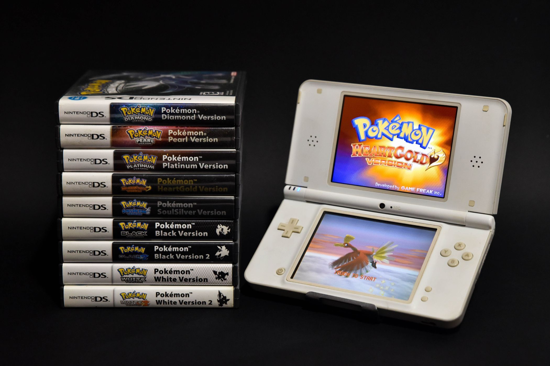 White Nintendo DS and Pokemon Games with a Black Background