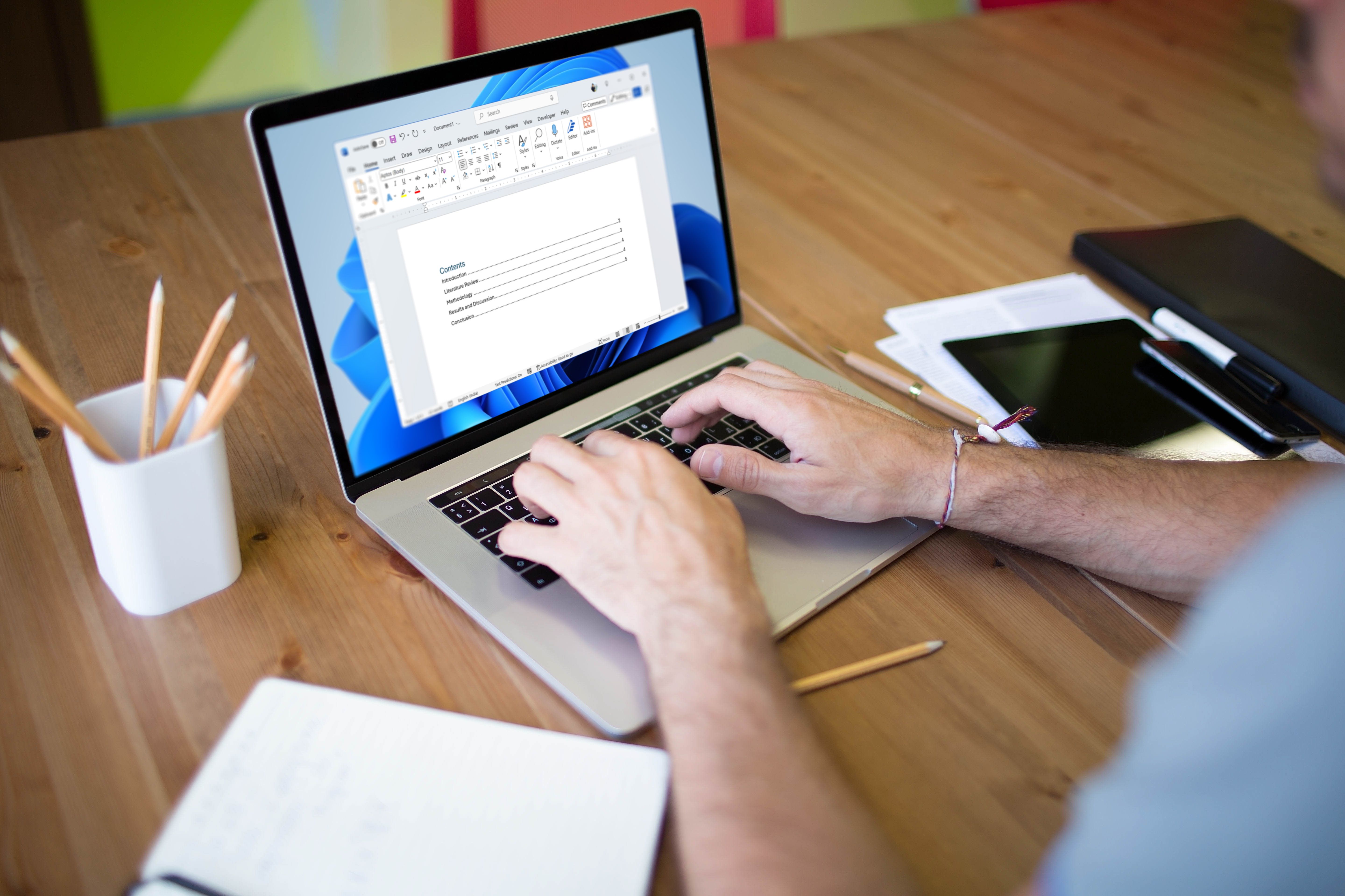 Person using a laptop to make a table of contents in Microsoft Word