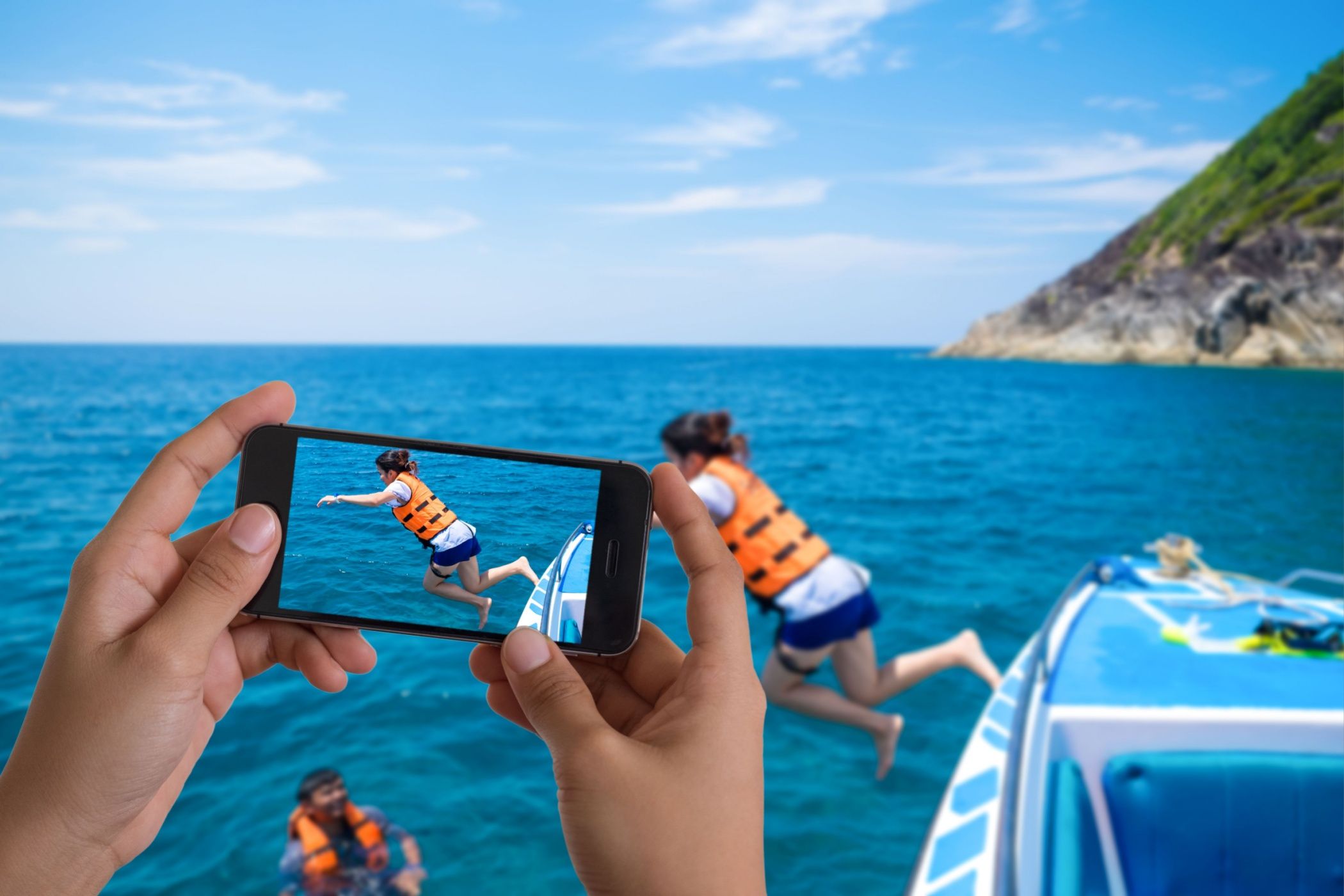 Taking photo of snorkeling divers jump in the beautiful sea