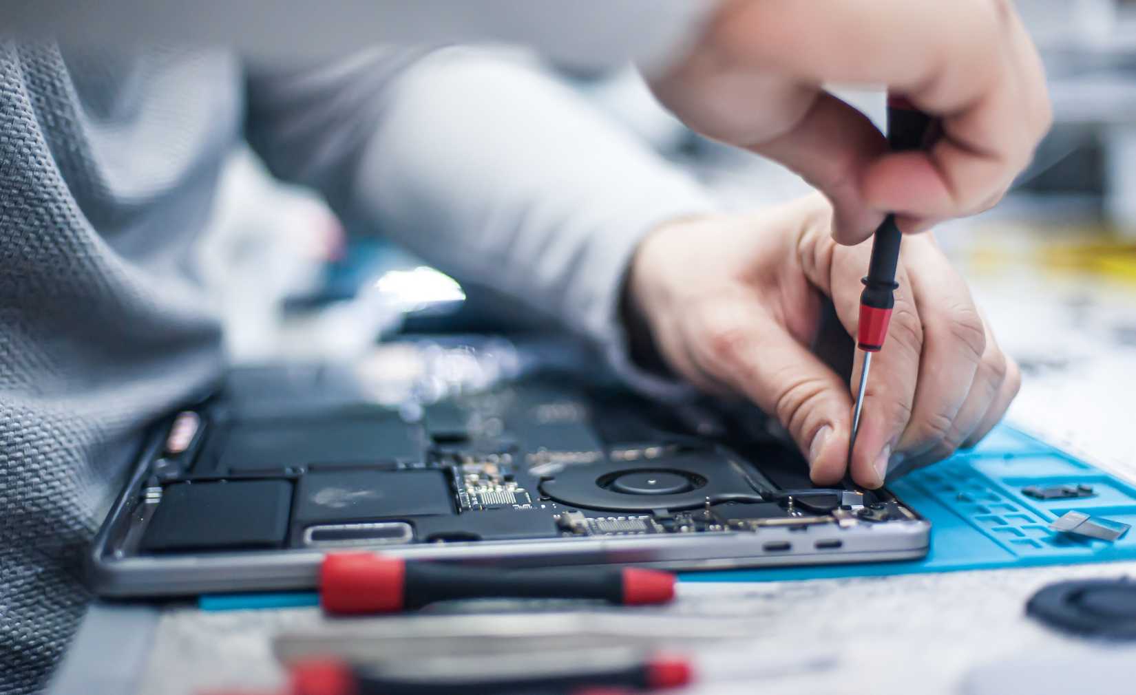A man repairing a laptop