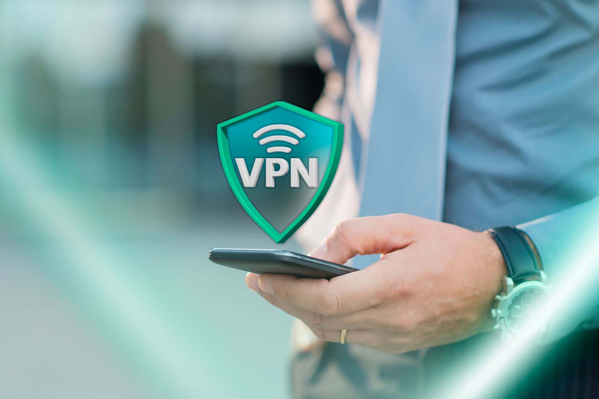 A person holding a phone with a VPN icon hovering above the screen.