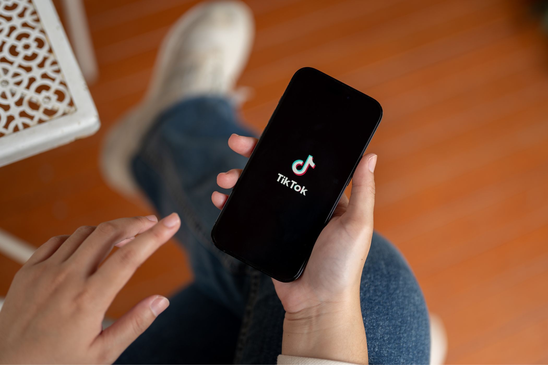 a person holding a smartphone with the tiktok app