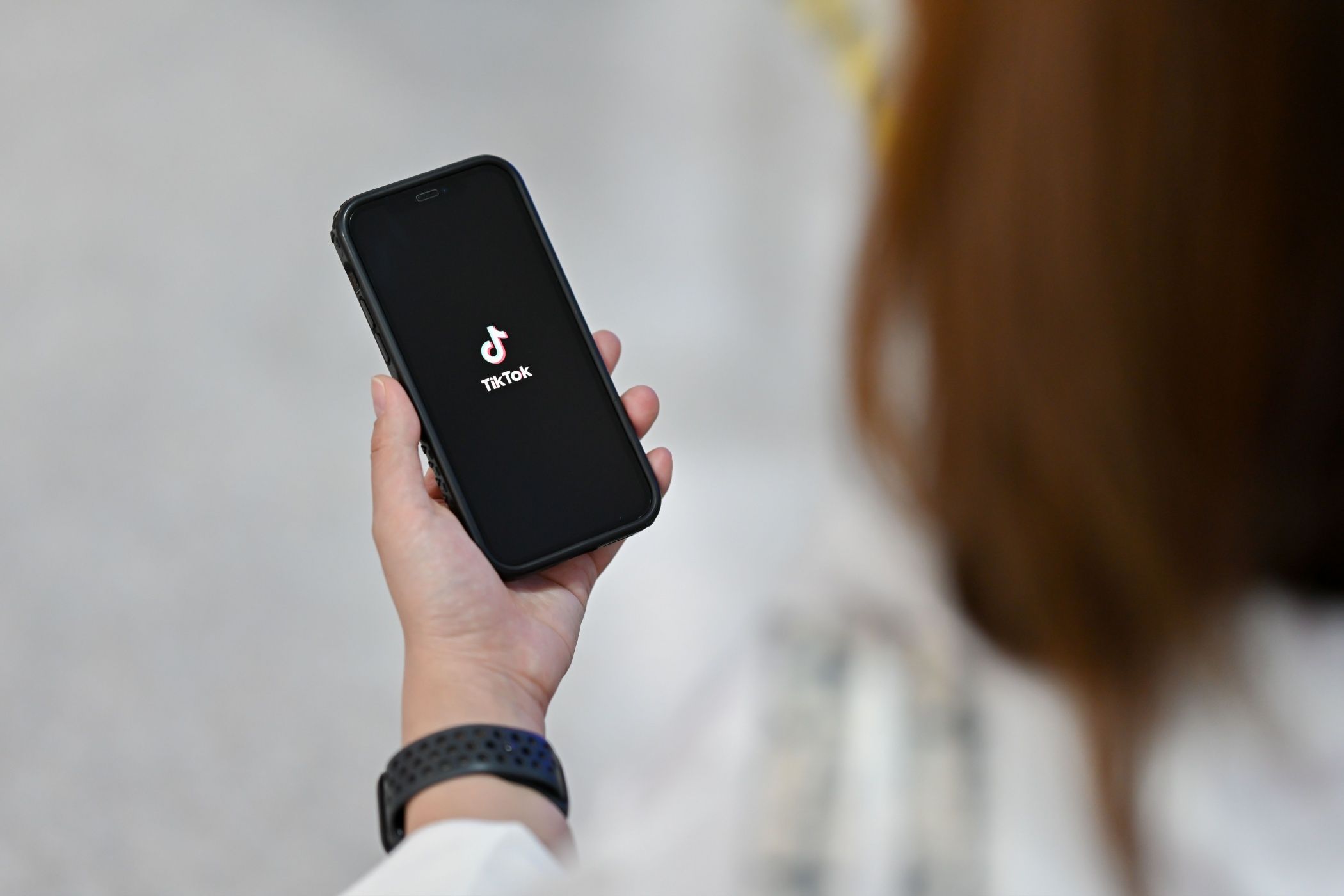 a person holding a smartphone with the tiktok app