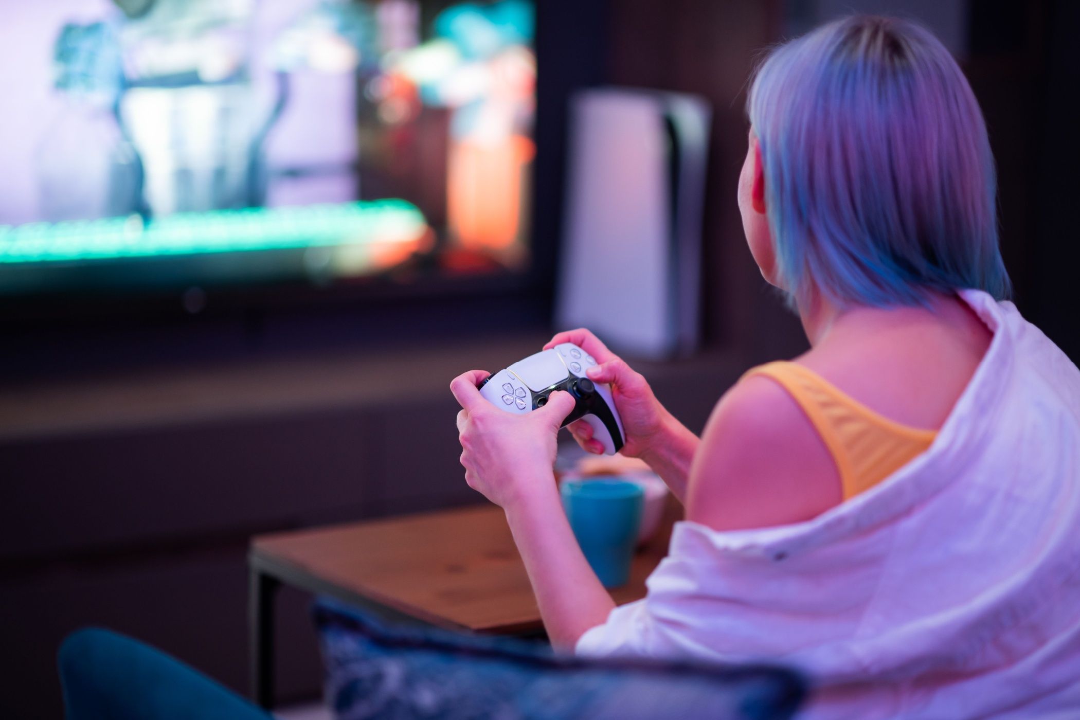 a woman gaming on a ps5 console