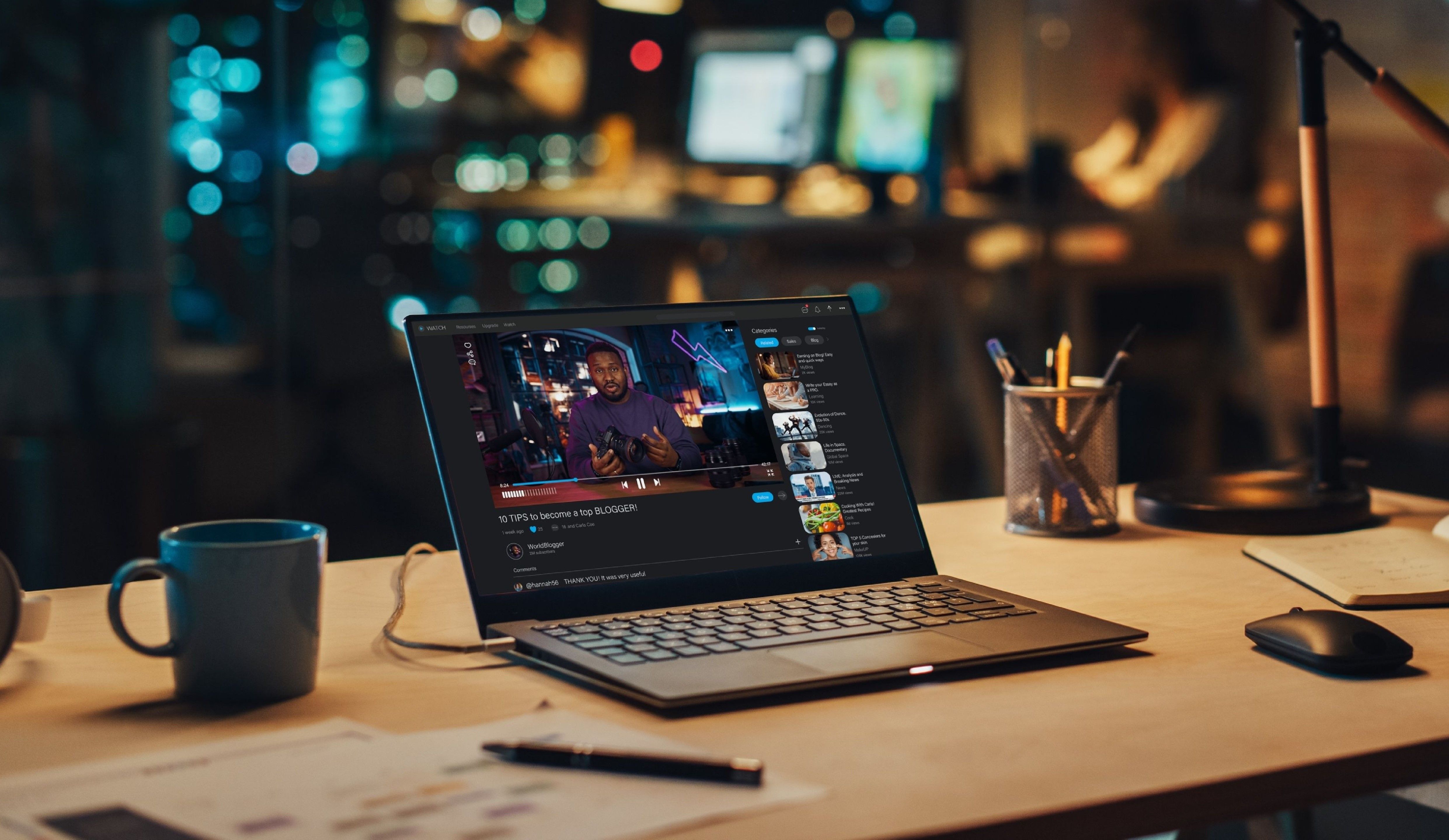 Laptop propped on desk in soft lighting, with youTube video playing