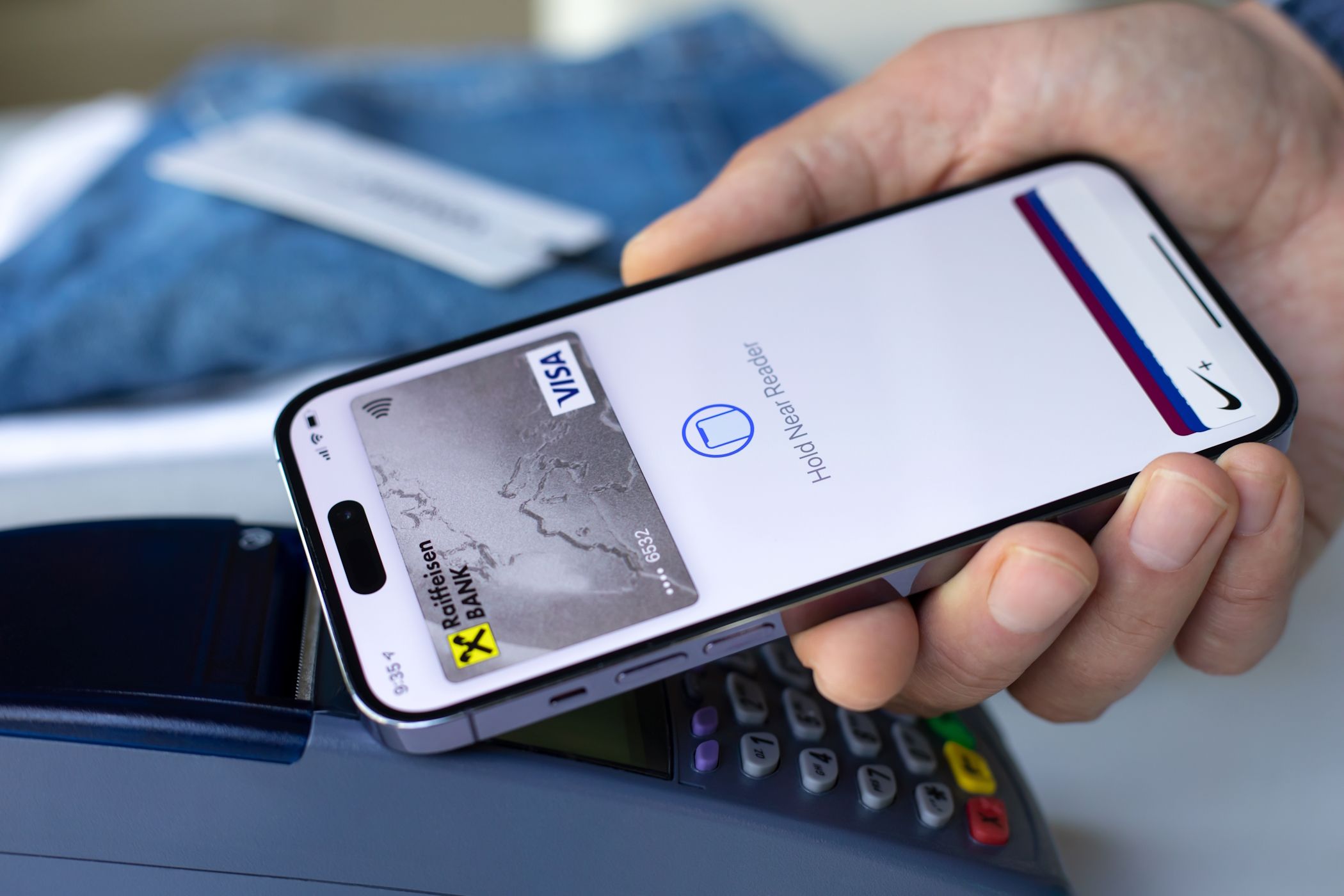 A man using Apple Pay on iPhone for a merchant transaction