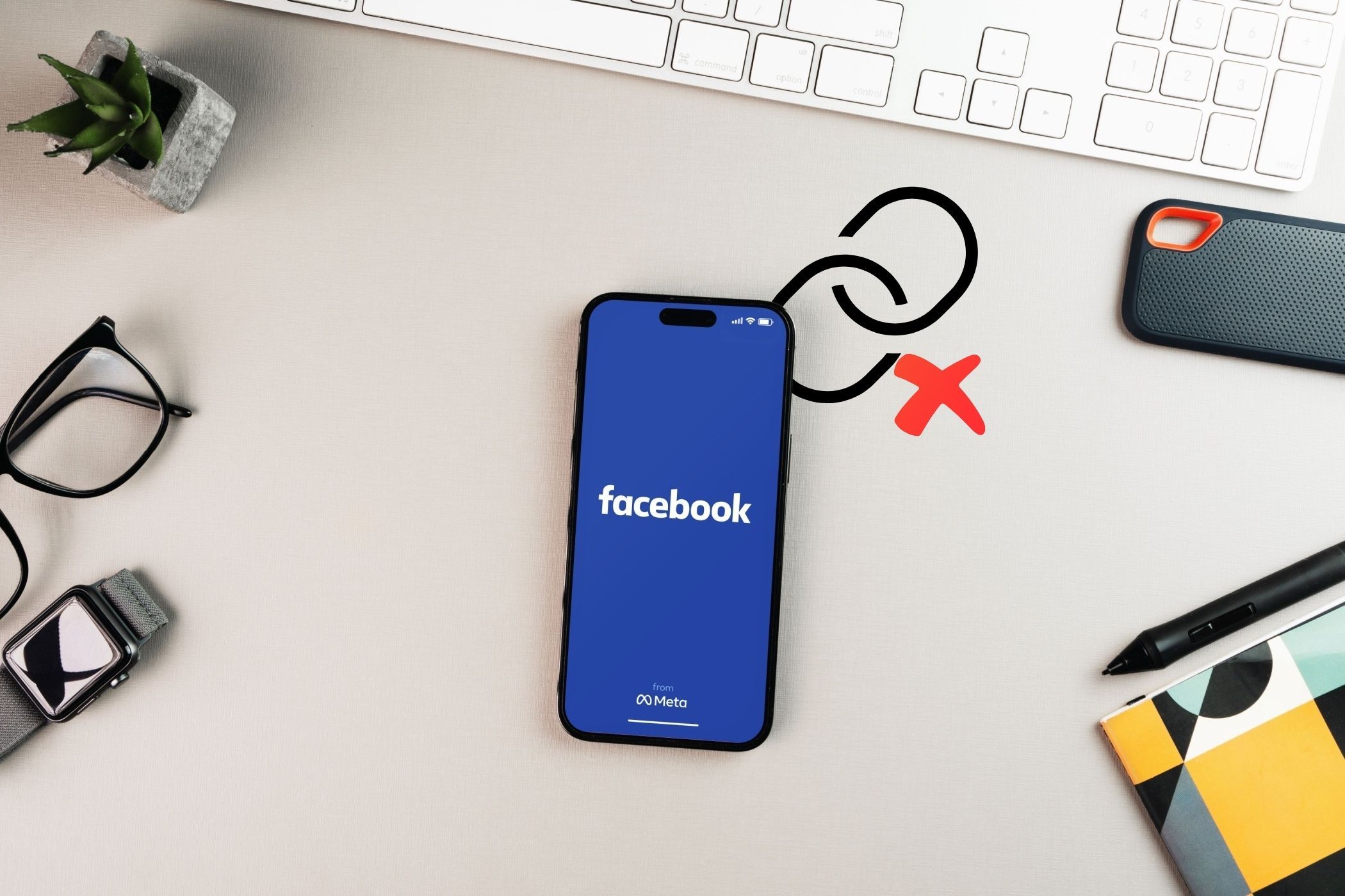 a smartphone on a desk with the facebook app and a link icon with a cross
