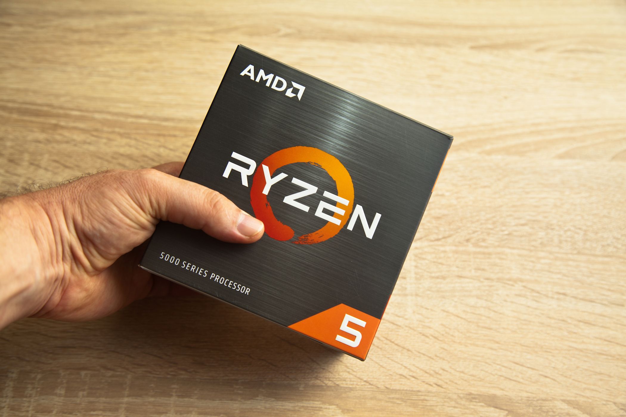 man holding ryzen 5 5000 series processor box