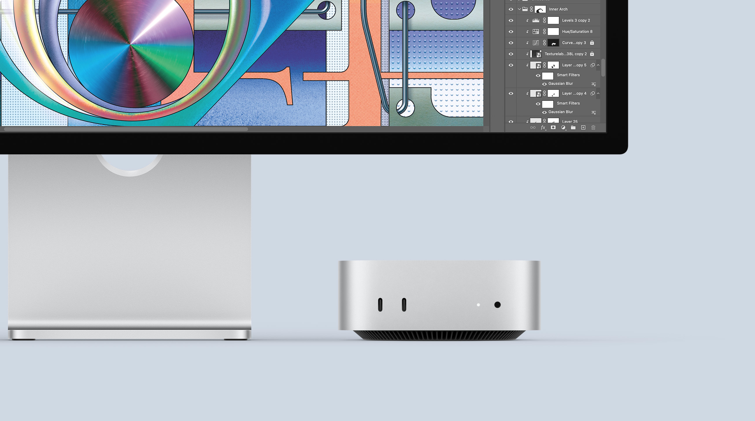 Mac Mini running Photoshop with a monitor in the background