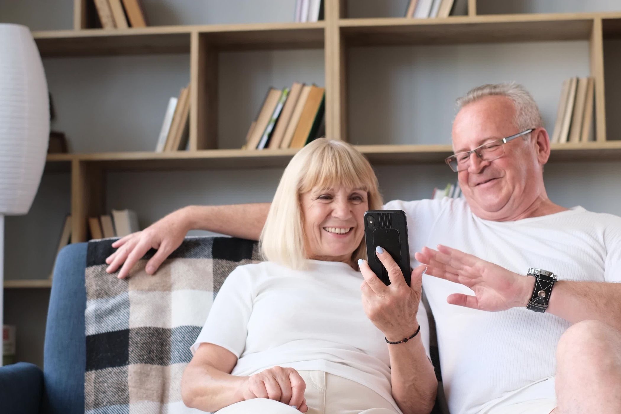 Elderly couple video calling on mobile phone