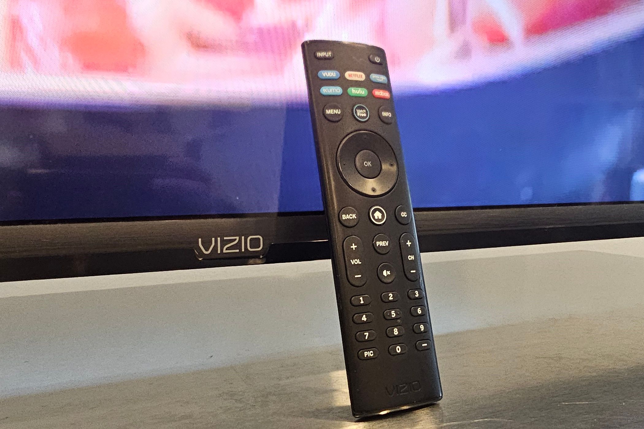 vizio smart tv remote next to vizio tv