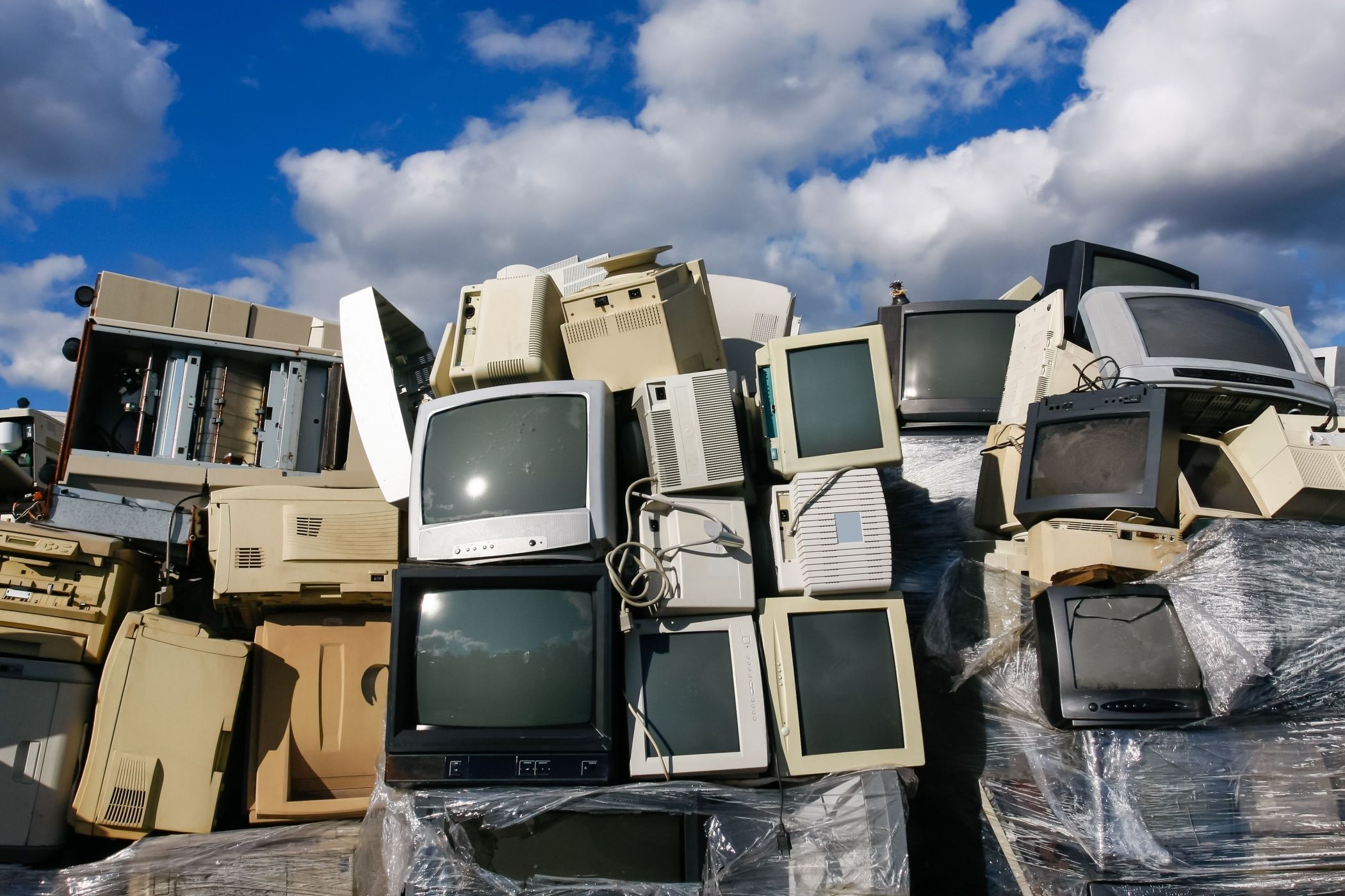 A pile of TVs on a garbage heap