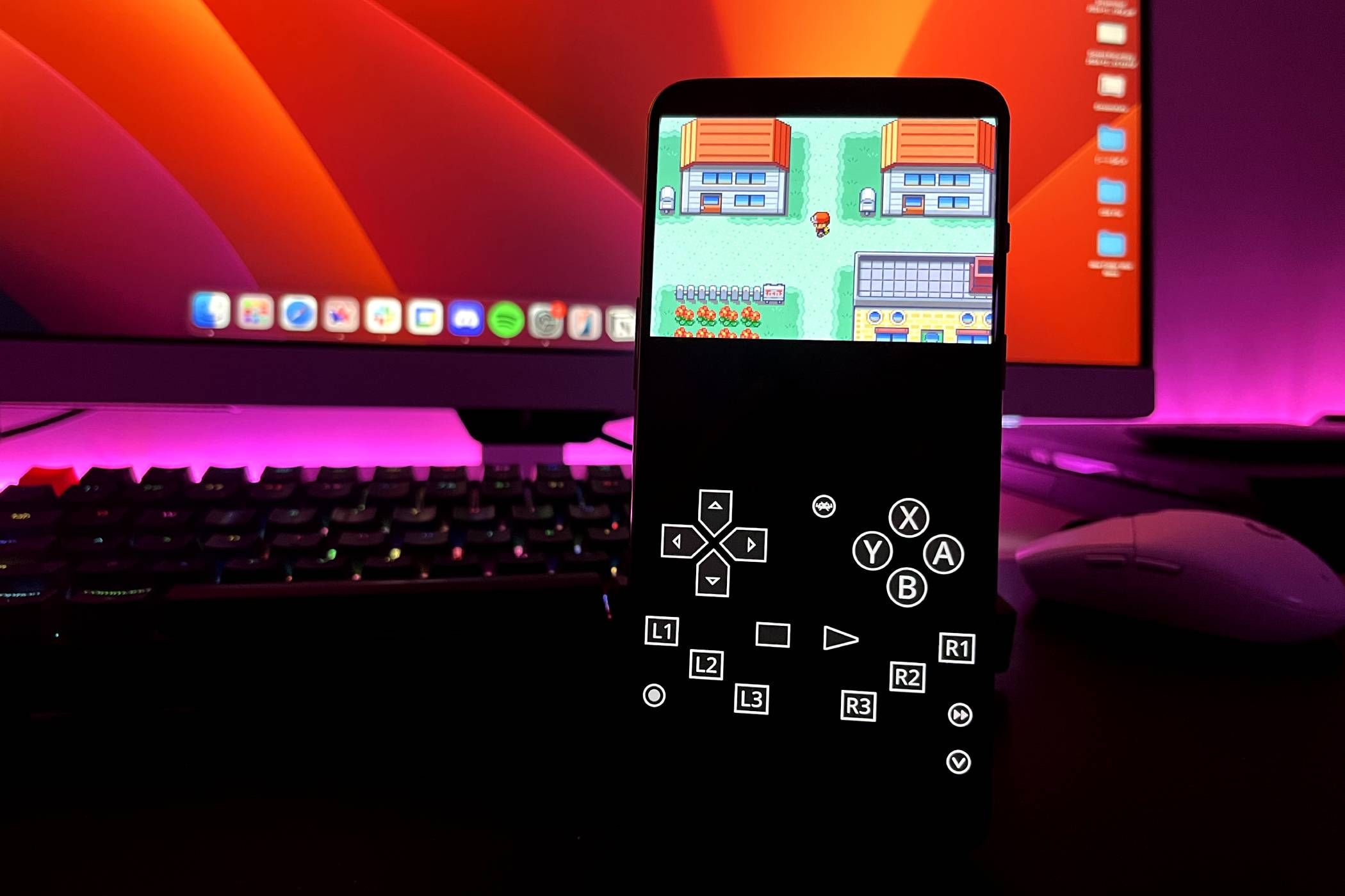 An Android Phone Running Pokémon: Fire Red on RetroArch With a Keyboard, Mouse and a Monitor in the Background